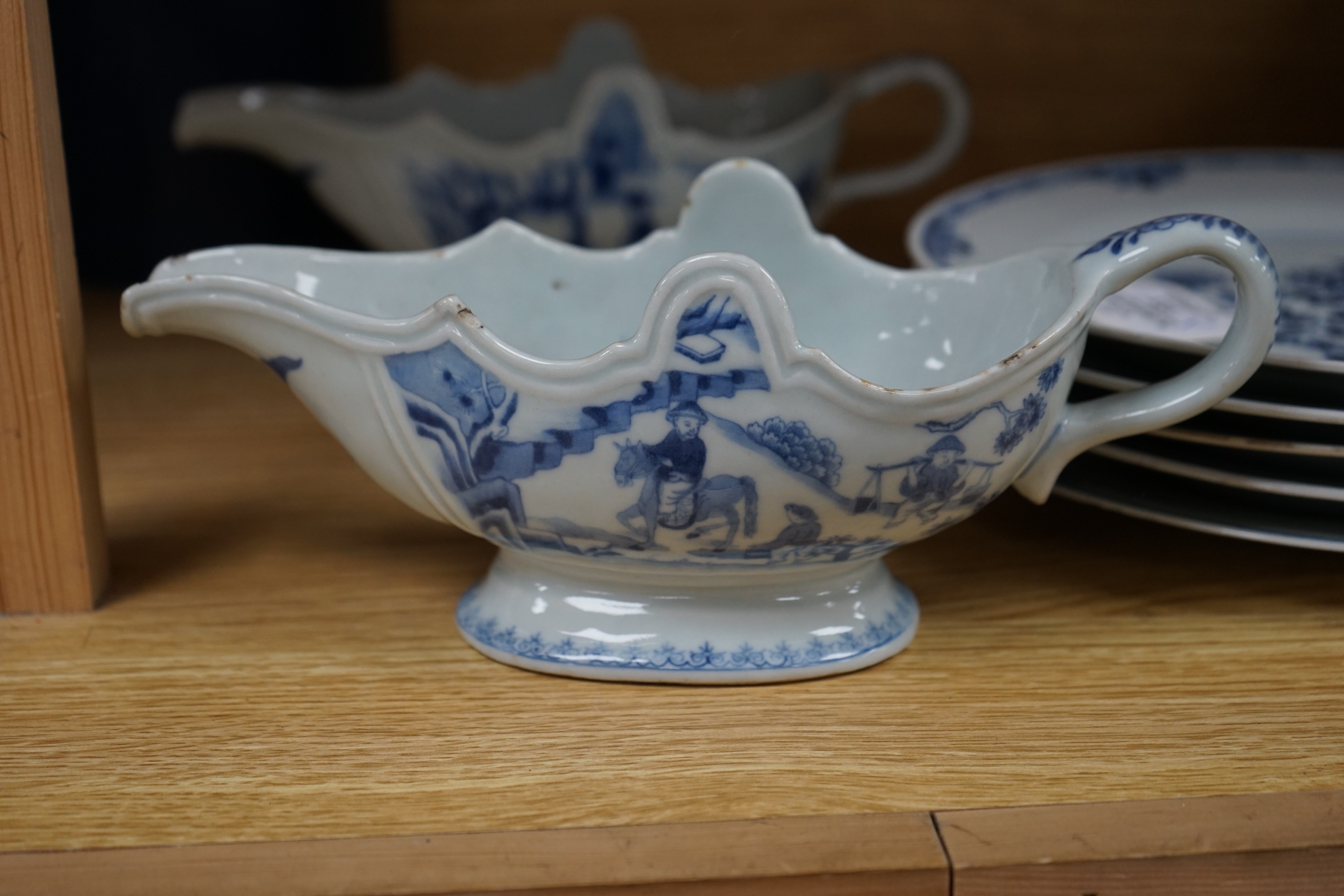 An 18th century Chinese Export blue and white octagonal tureen and cover, decorated with birds and flowers, a pair of similar sauceboats and five plates decorated with urns of flowers